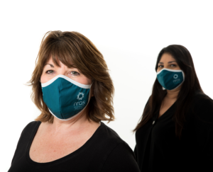 2 women wearing NRAS face masks standing at a distance